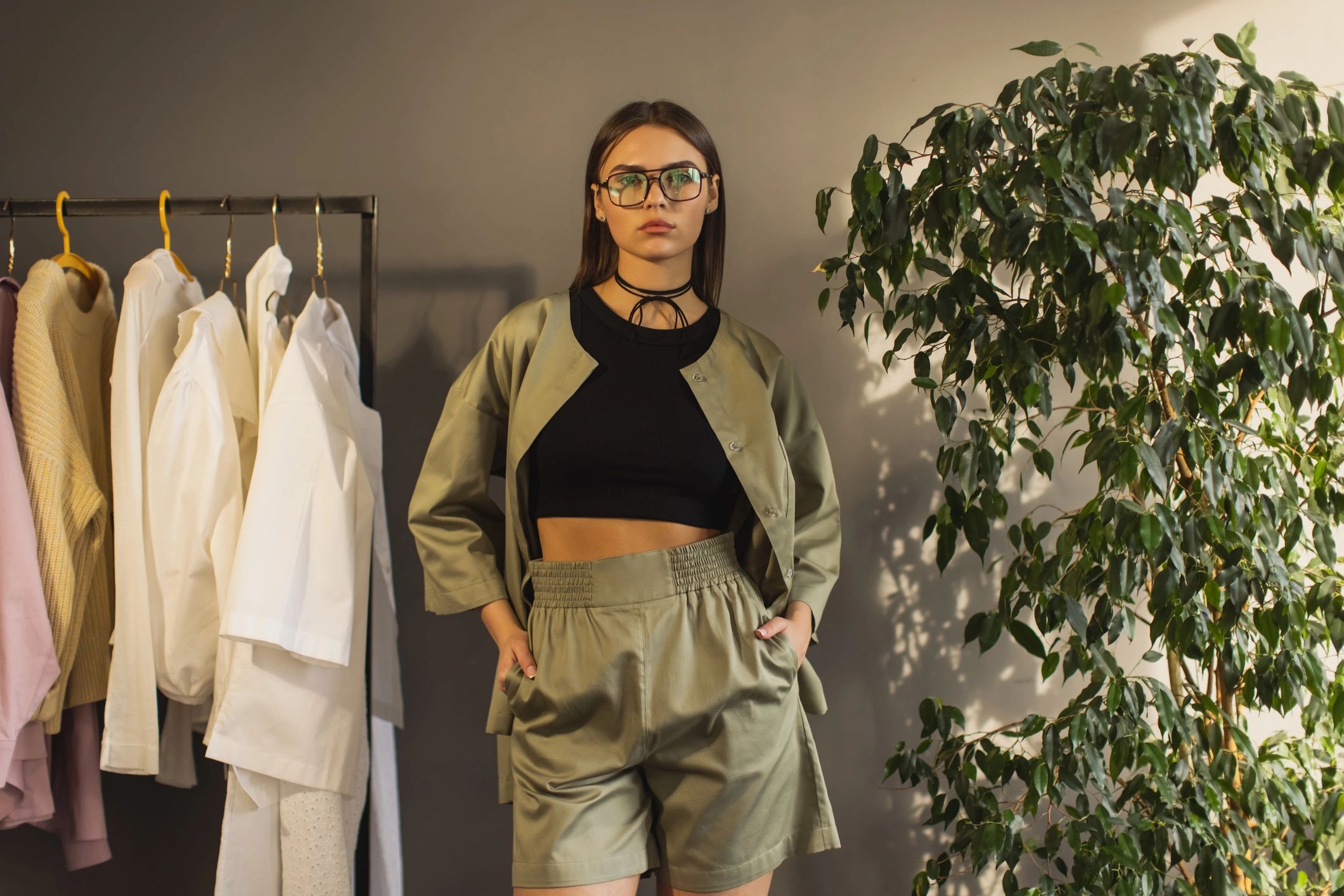 Model selecting minimalist clothing on a rack